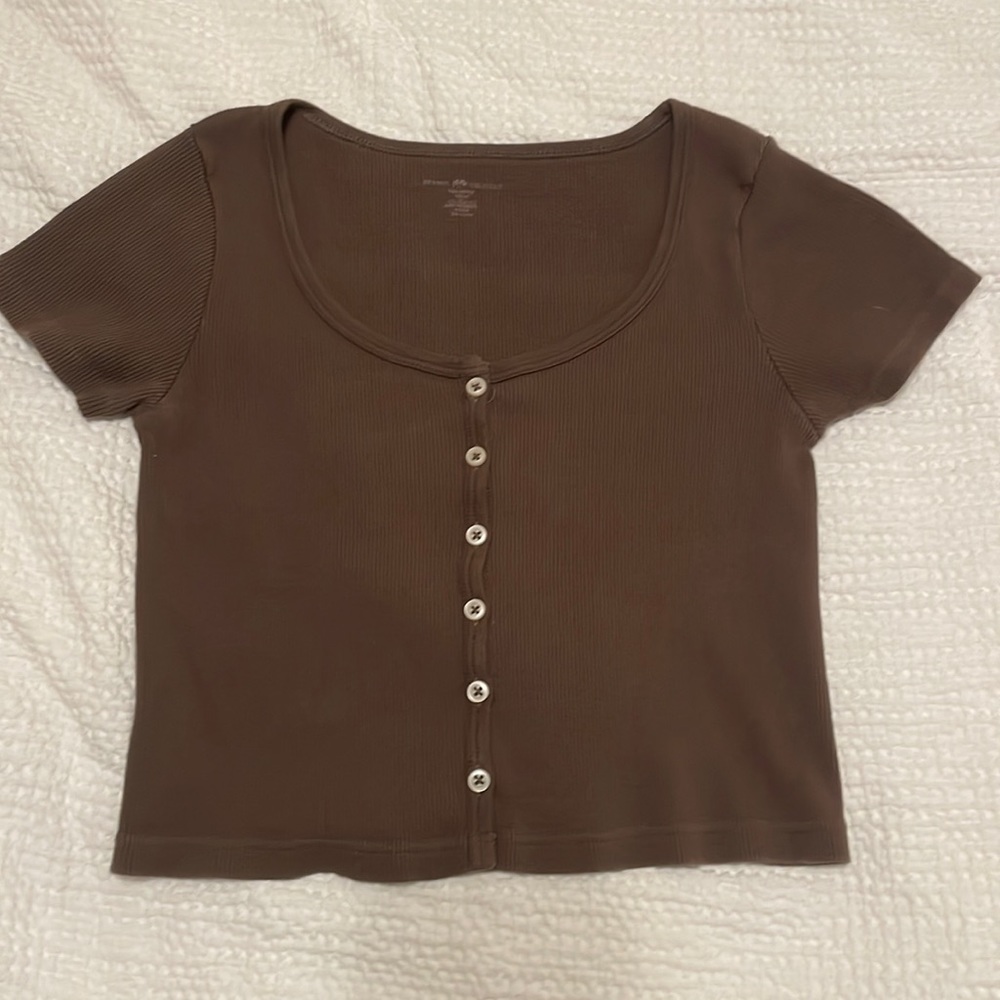 dark brown tee, cream buttons going down middle. brandy Melville